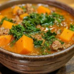 A bowl of hearty sausage sweet potato kale soup